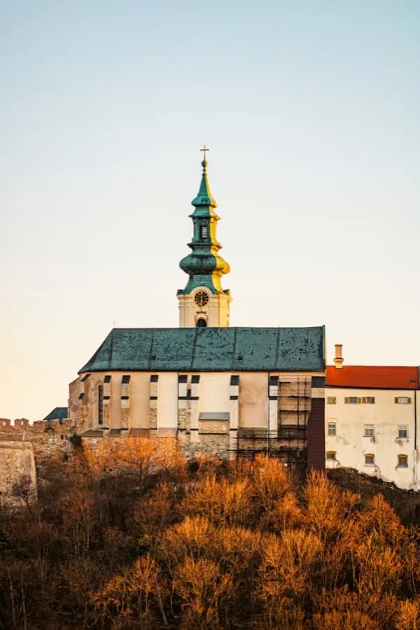 eSIM Nitra Slowakei - Mittelalterliche Burg Nitra über der Altstadt mit dem Nitra-Fluss im Vordergrund