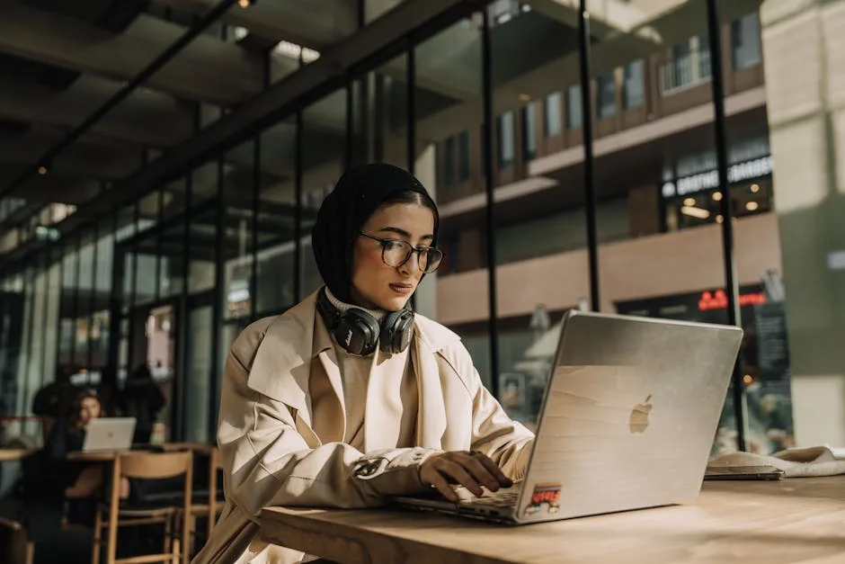 Digital nomad working at a laptop in a coworking space using eSIM internet