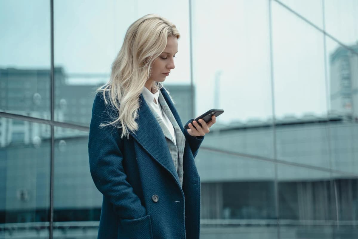 Traveler using the HelloRoam app to activate a travel eSIM plan at an international airport