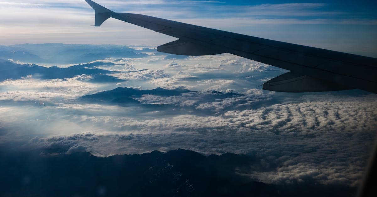 Stunning view of the Swiss Alps and clouds from an airplane window. Perfect for travel enthusiasts.