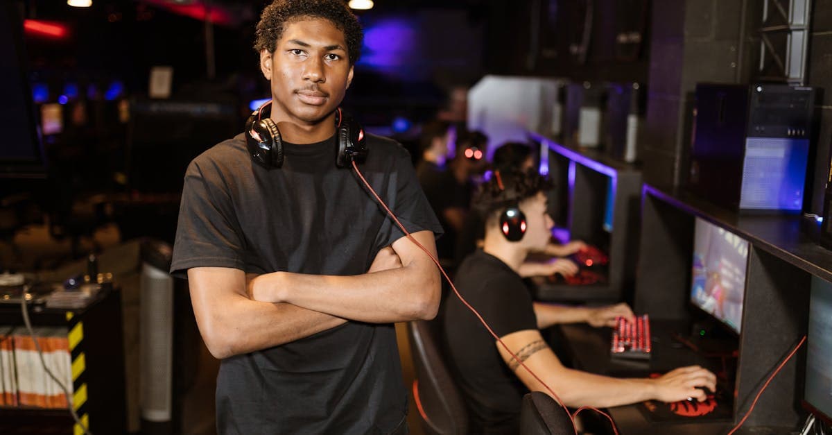 Confident young gamer standing arms crossed in an esports arena, evoking the internet cafe boom era.
