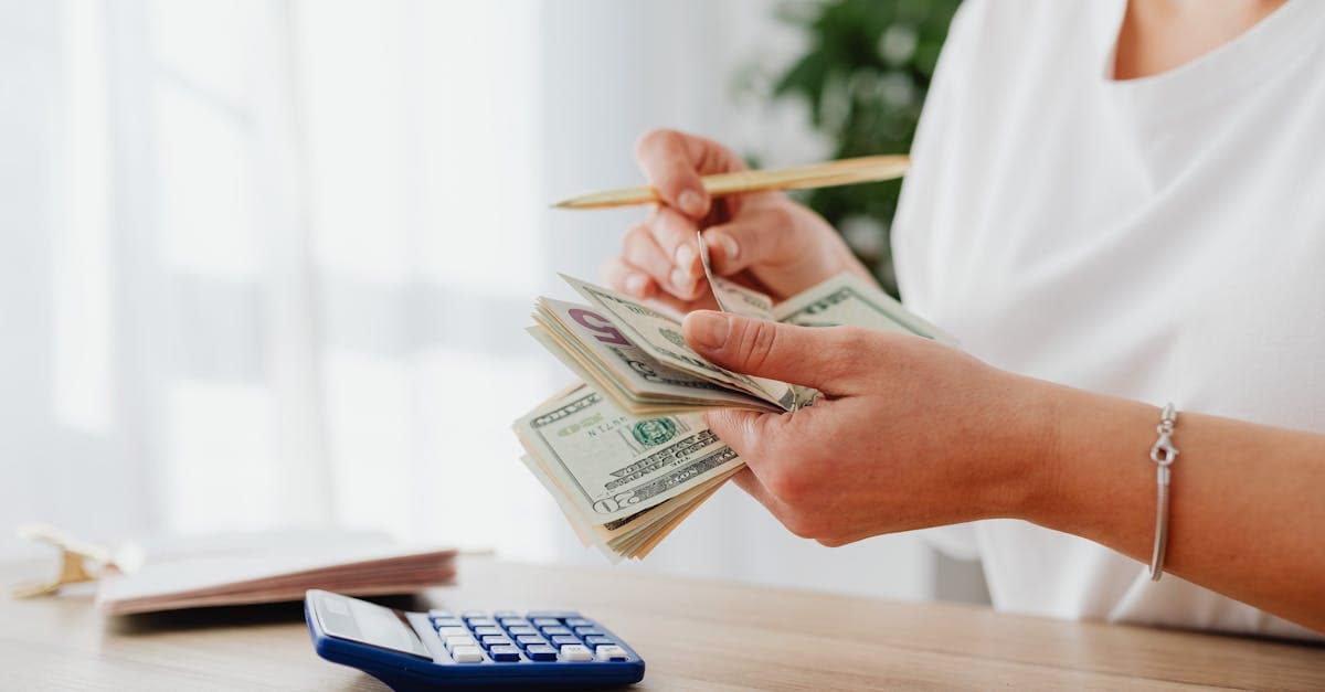 Woman counting US dollars at home, budgeting application fees and hidden costs for the digital travel eSIM visa spain