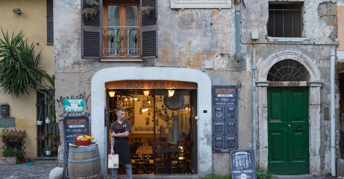 Entrada rústica de uno de los restaurantes en Roma del barrio de Trastevere, con encanto italiano auténtico.