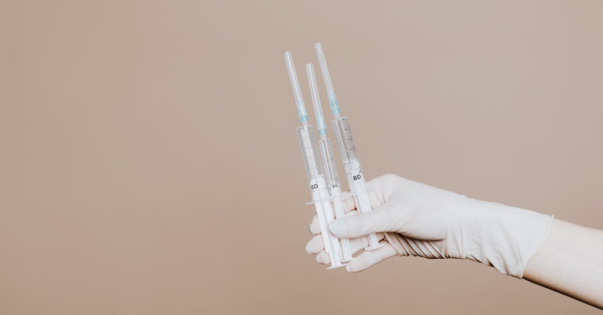 Gloved healthcare worker holding multiple syringes, representing travel vaccinations services at an Irish clinic