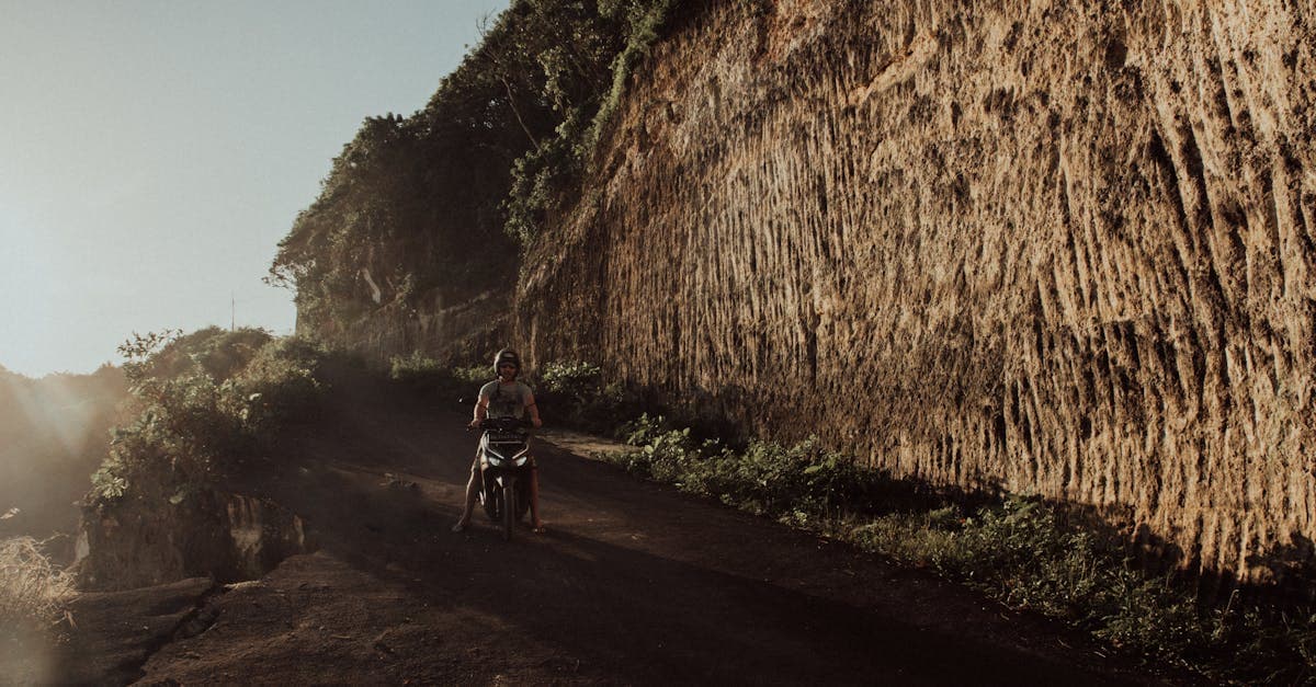Motor scooter on a rugged Bali road at sunset, scooter hire risks explained for those asking is Bali safe