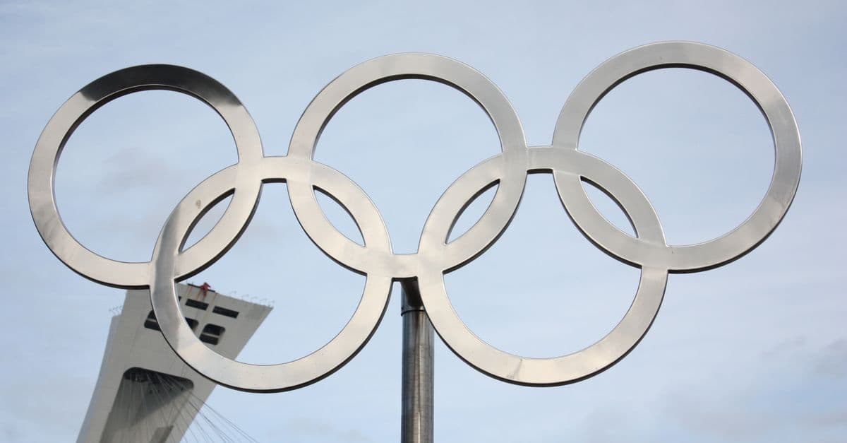 Olympic rings monument against a clear blue sky, symbolizing the spirit of the 2028 Los Angeles Games.