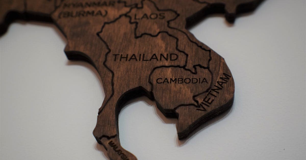 Wooden map of Southeast Asia with country names engraved, featuring Cambodia, Malaysia, Philippines and Laos