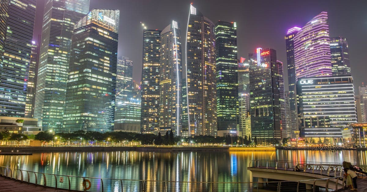 Vibrant Marina Bay skyline at night reflecting on the waterfront, perfect for a Singapore itinerary