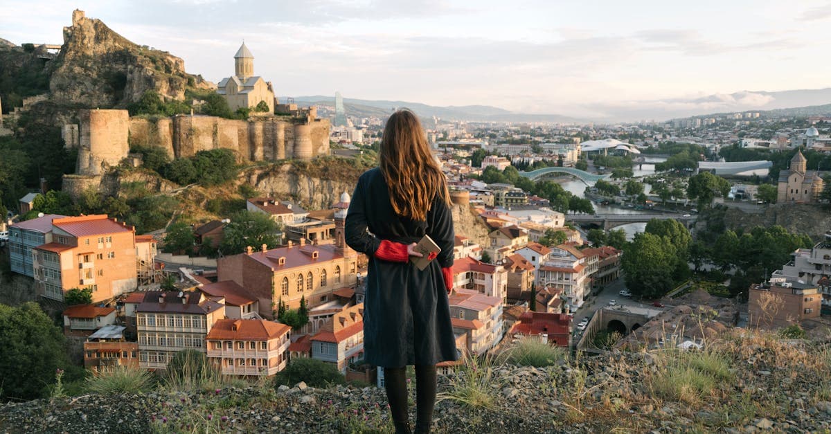 Woman overlooking Tbilisi's historic skyline and fortress, one of Europe's most underrated solo travel cities