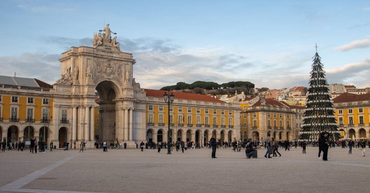 Lisbon's Praça do Comércio with a Christmas tree and illuminated archway, among the best Europe cities to visit in December