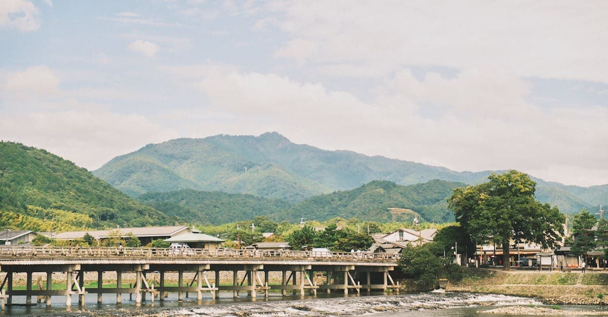 Arashiyama's scenic bridge and lush mountains in Kyoto during Japan's hot and humid summer season