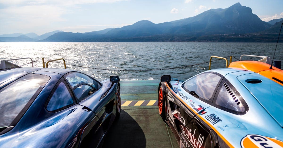 Auto sportive parcheggiate sul Lago di Garda con vista sulle montagne, meta ideale per i tifosi in trasferta.