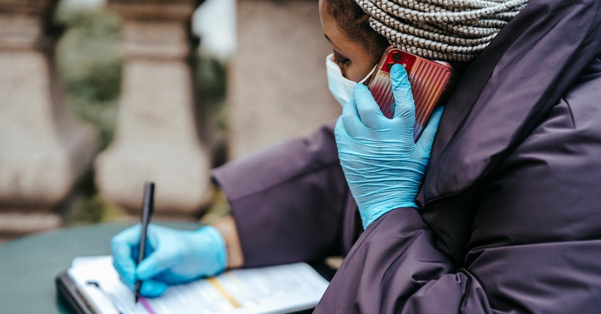 A healthcare professional in sterile gloves taking notes, representing health and insurance essentials before travelling to Egypt