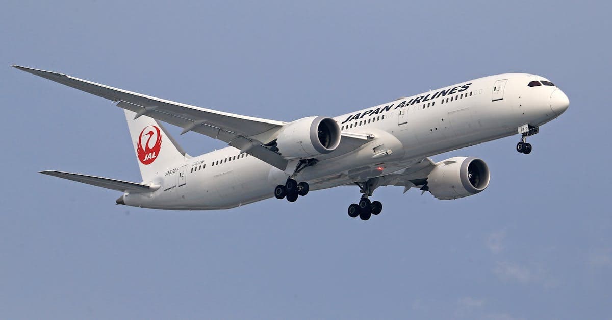 Japan Airlines aircraft descending with landing gear extended, representing direct flights to Japan from Australia