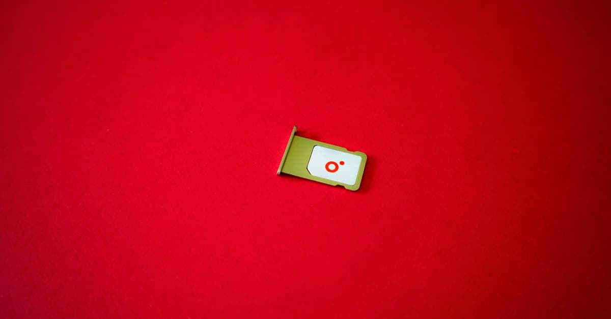 A clean image of a SIM card tray displayed on a vibrant red background.