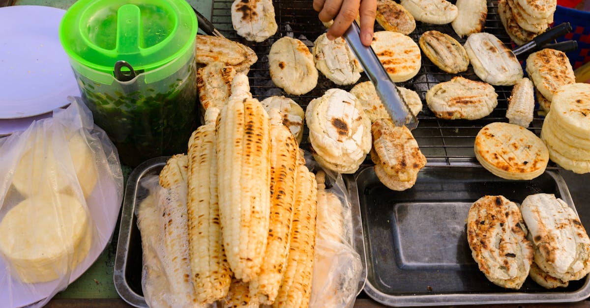 Grilled corn and rice cakes displayed at a local Vietnamese street food market stall