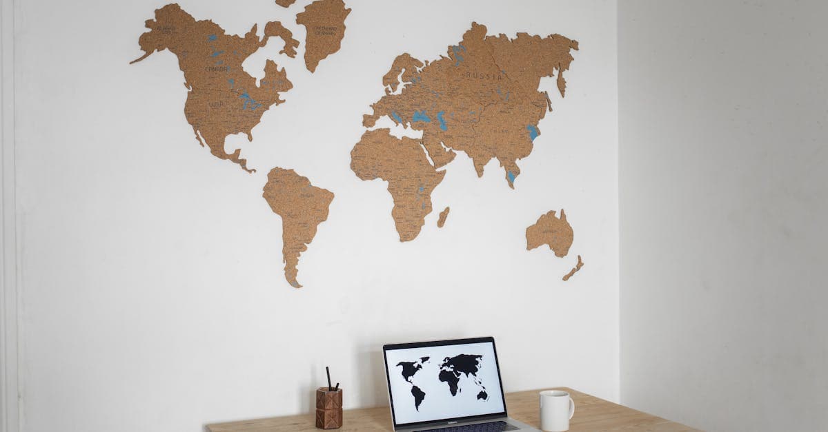 Minimalist workspace setup for choosing the best countries for digital travel eSIMs, featuring a cork world map.
