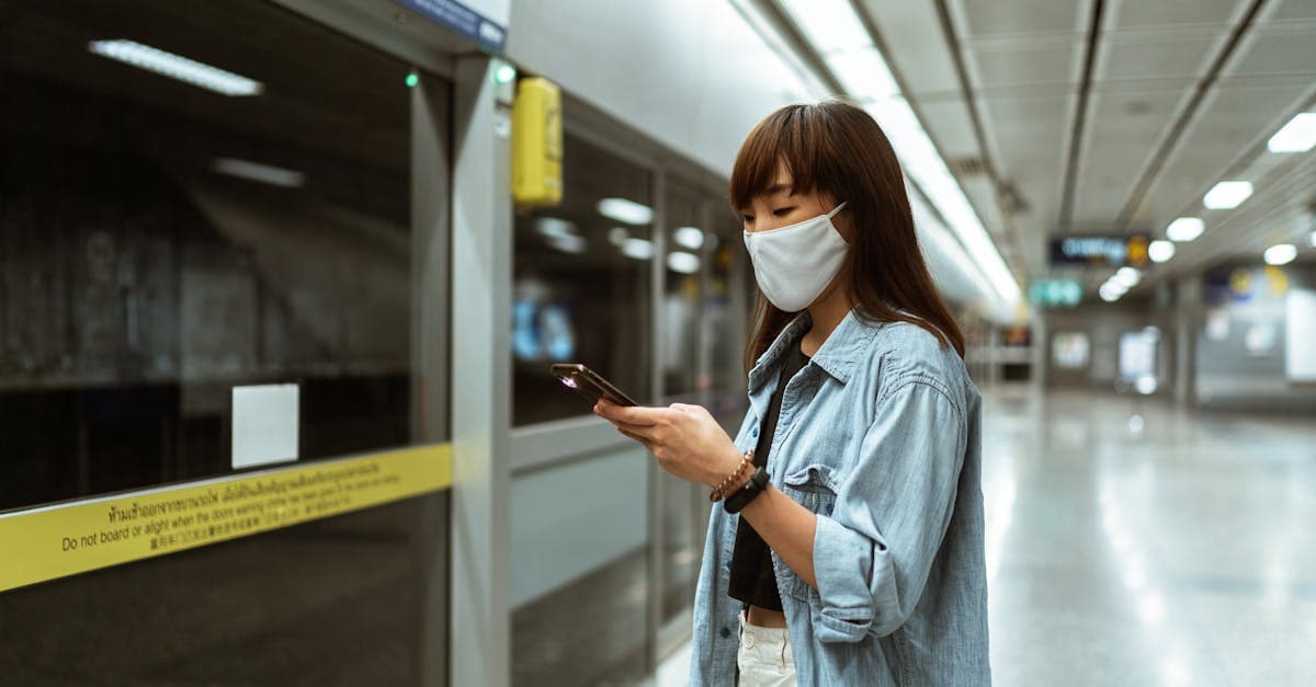 Traveller using a smartphone at a Bangkok metro station with full esim thailand network coverage