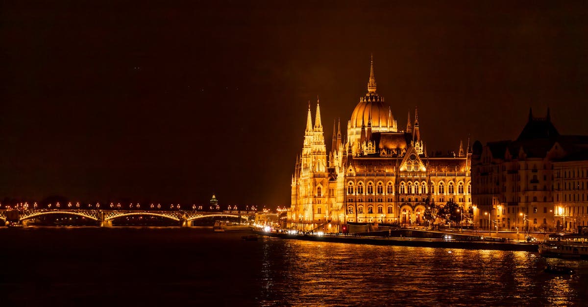 Parlamento di Budapest illuminato di notte riflesso sul Danubio, tra le mete economiche europa centrale