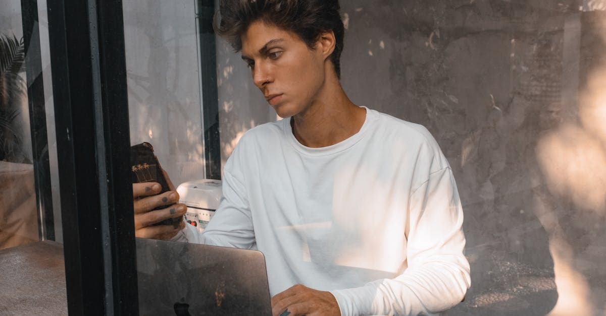 Young man in a café reviewing Singapore tax rules applicable to digital travel eSIM visa holders