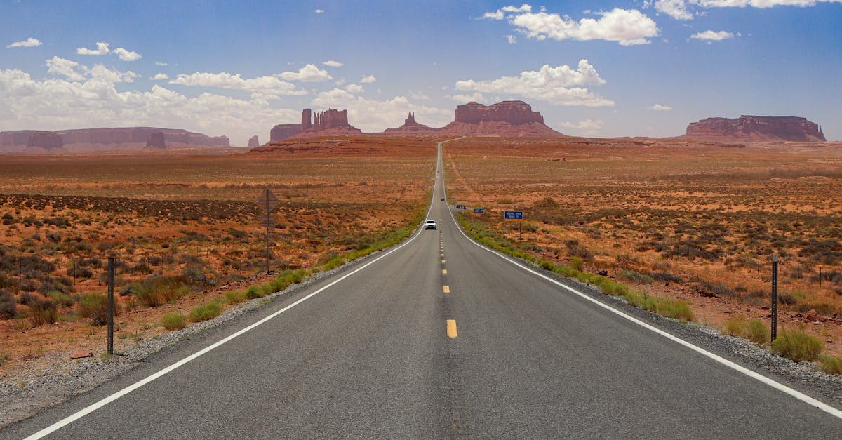 Empty highway stretching through Monument Valley, the perfect road trip travel destination.