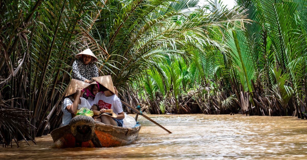 Australian traveller on a traditional boat through the Mekong Delta, made possible with a vietnam visa for australian visitors.
