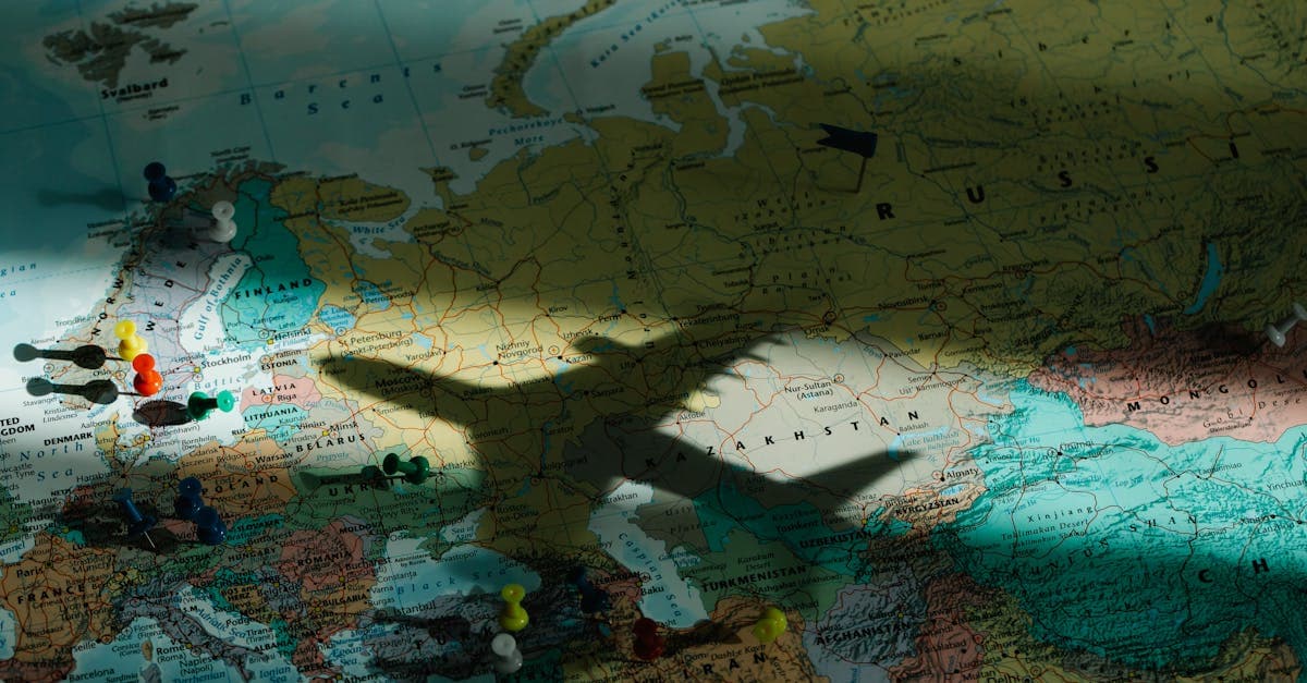 Airplane shadow cast on European map representing safe, accessible travel to the world's cheapest countries to visit.