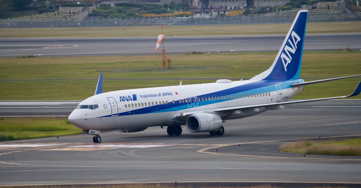 ANA aircraft taxiing on the runway at a Japanese airport, ideal for planning a two-week trip to Japan.