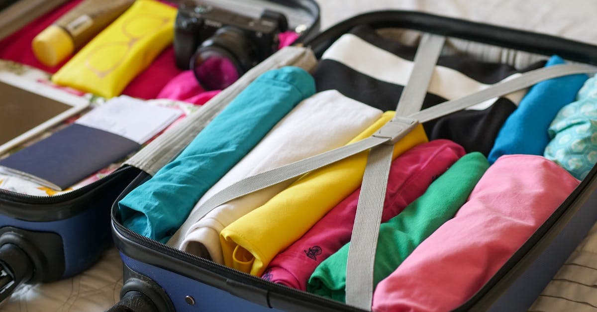 Neatly organized suitcase with colorful clothes and travel essentials packed before departure