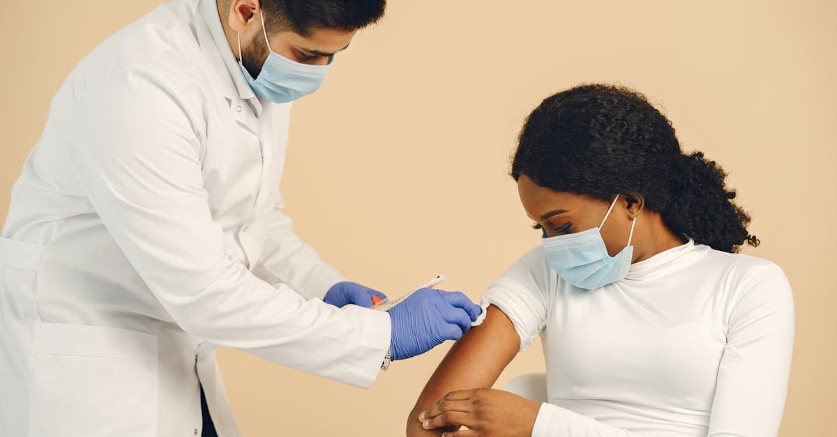 Healthcare worker administering travel vaccinations to a patient at a Canadian travel health clinic
