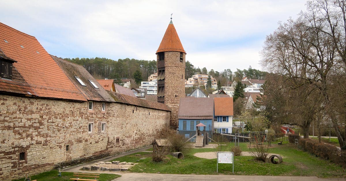 Scenic view of historic tower in Weil der Stadt surrounded by spring greenery and traditional architecture.
