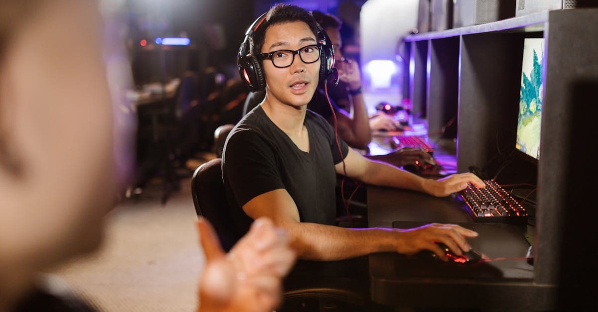 Adult men engaged in competitive gaming at a modern internet cafe arcade setting today.