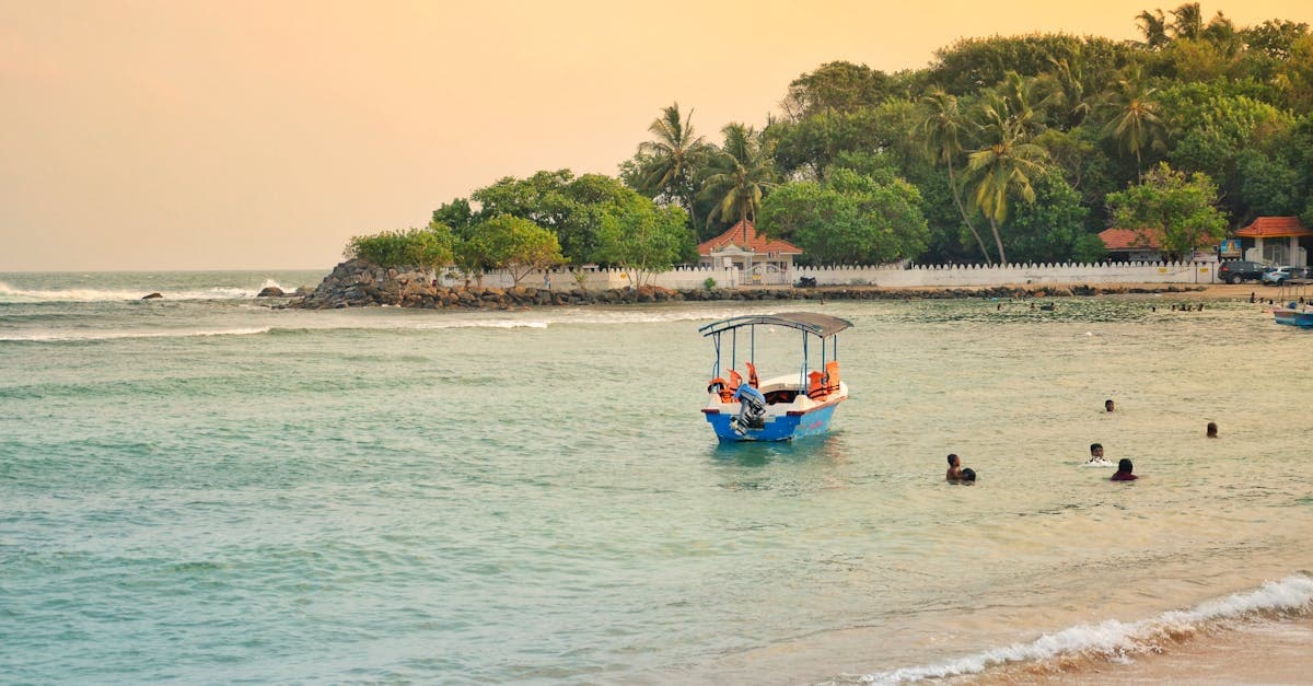 People swimming from a traditional boat off the Sri Lanka coast at sunset, a highlight of any 7-day itinerary