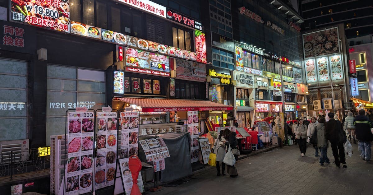 Busy Seoul street with restaurants, market signs, and local eateries showcasing Korean dining culture.