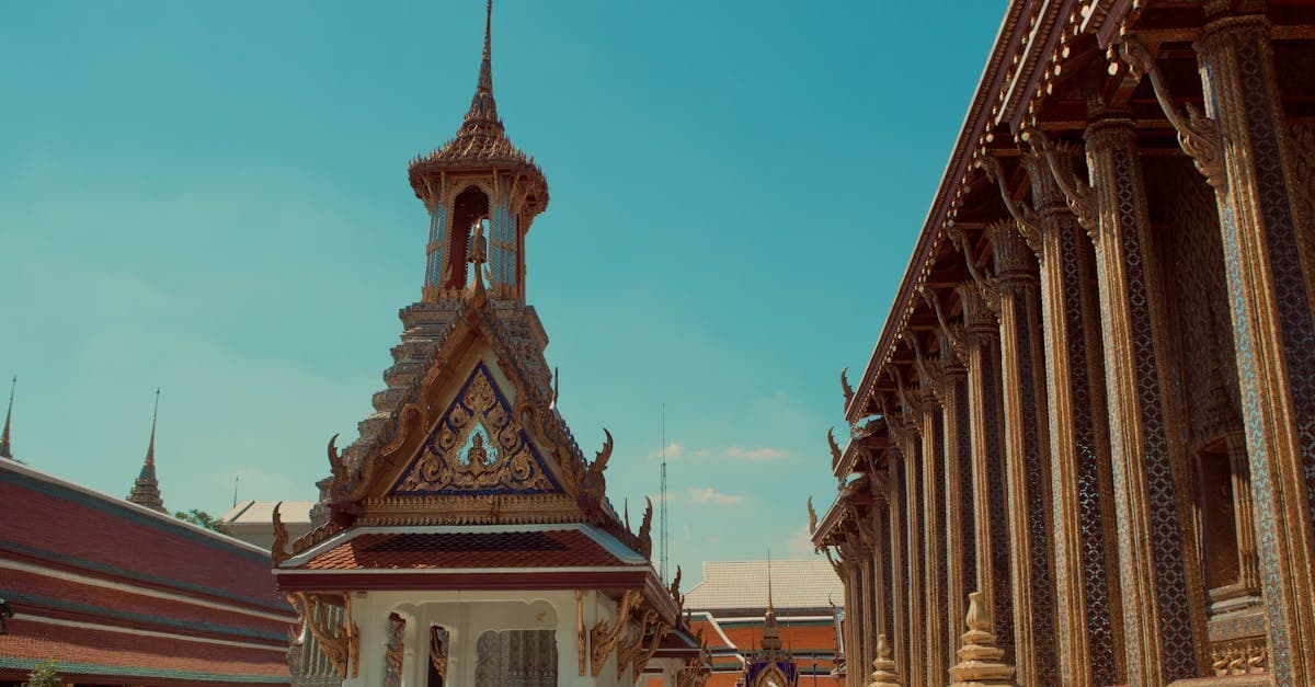 Intricate details of Wat Phra Kaew's golden spires showcase exceptional architecture among places to visit in Thailand