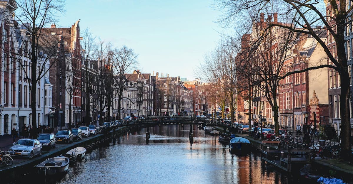 Tranquil Amsterdam canal lined with historic buildings, perfect for discovering hidden gems and things to do in amsterdam