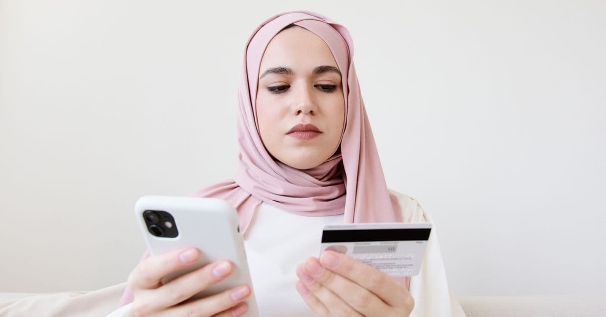 Femme en hijab activant son profil eSIM vodafone via QR code pour configurer son forfait mobile