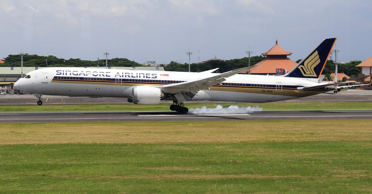 Singapore Airlines aircraft touchdown on runway, showcasing travel and aviation.