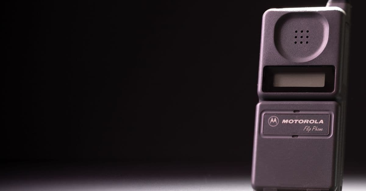 Motorola Razr flip phone stood upright on a dark surface, showcasing its sleek premium foldable design.
