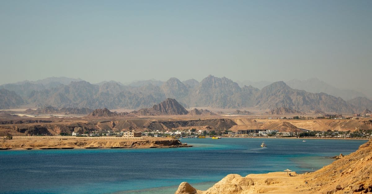 Montañas áridas y edificios junto a las aguas turquesas del mar Rojo en Egipto.