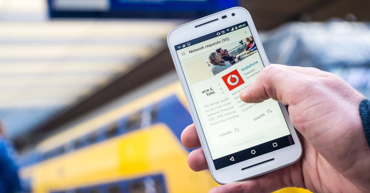 Person using a smartphone outdoors to contact Vodafone broadband UK customer support for help.