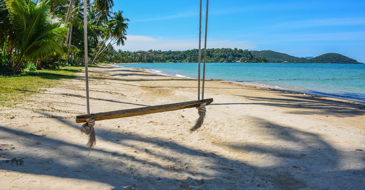 A swing on Ko Mak's sandy beach, where thailand weather stays hot and humid year-round