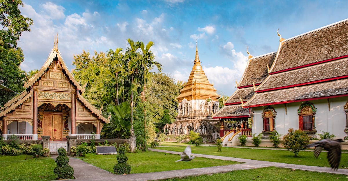 Chiang Mai's Wat Chiang Man temple surrounded by lush greenery, best time to visit Thailand to avoid peak heat