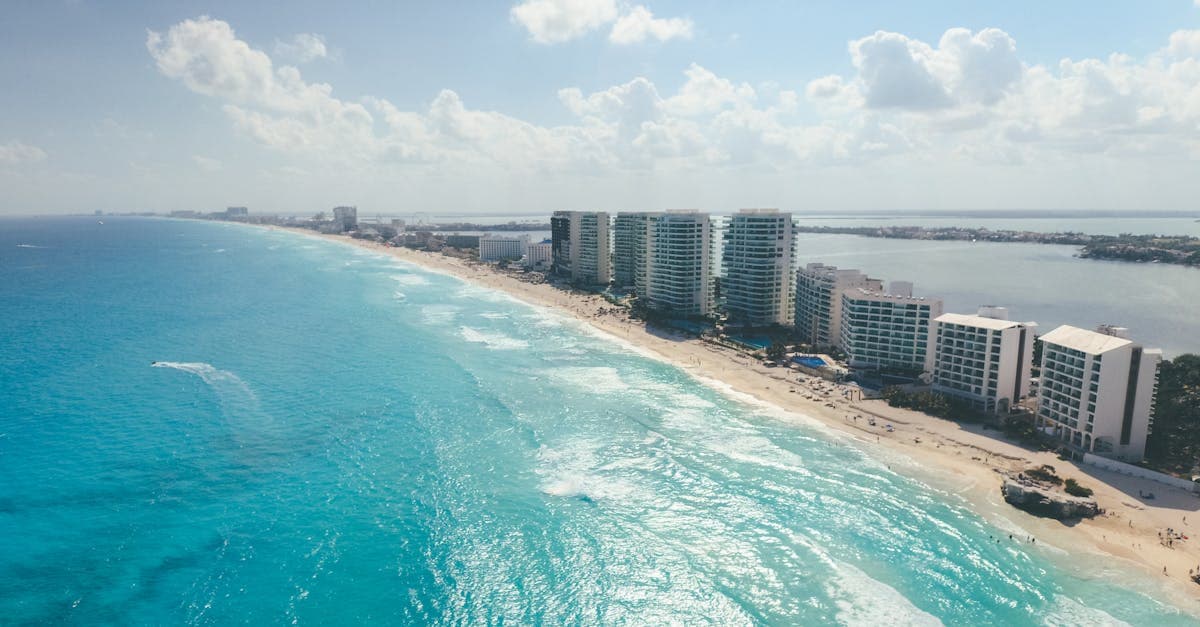 Cancun's beachfront hotel strip from above, representing the safer tourist corridors outside downtown areas