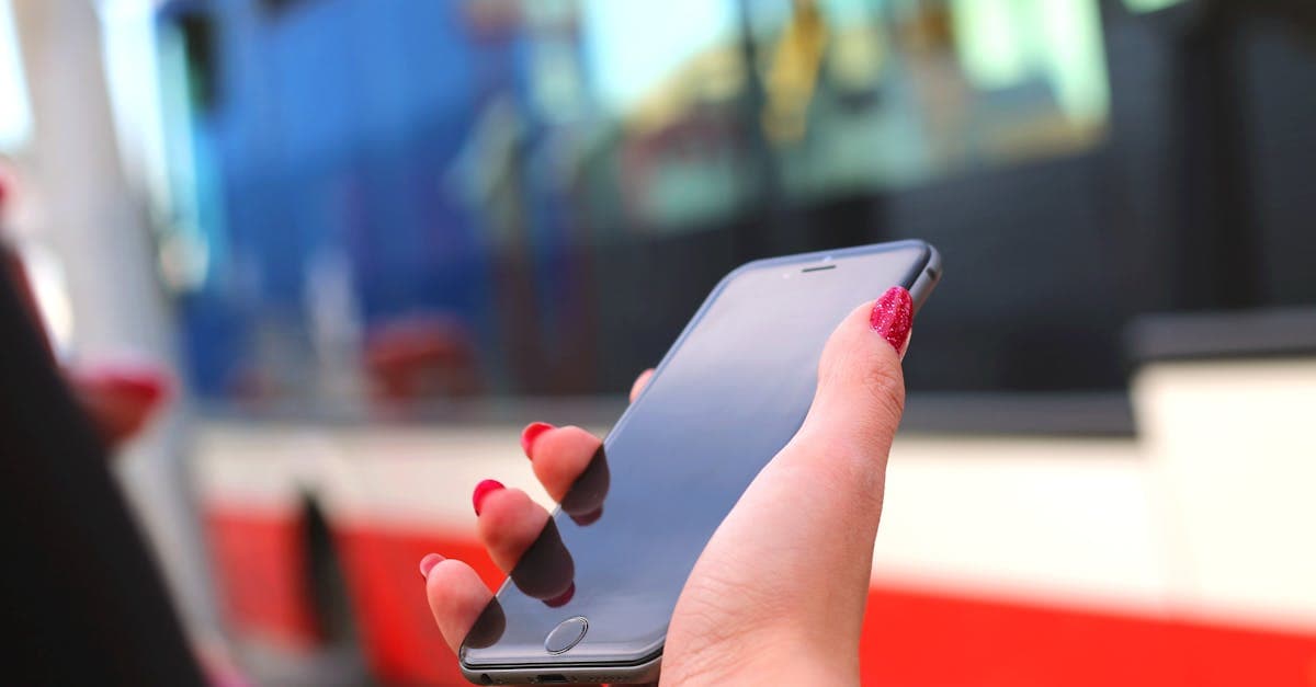 Kobieta z telefonem na przystanku autobusowym — jak aktywować eSIM u polskich operatorów