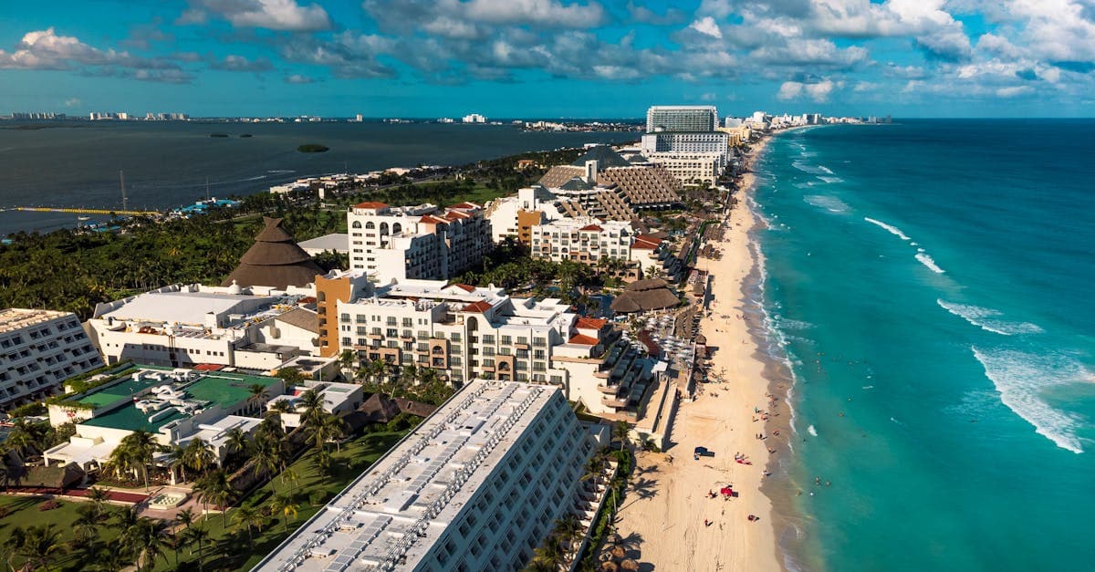 Cancun's vibrant beachfront resorts and turquoise sea from above, highlighting affordable off-season travel options