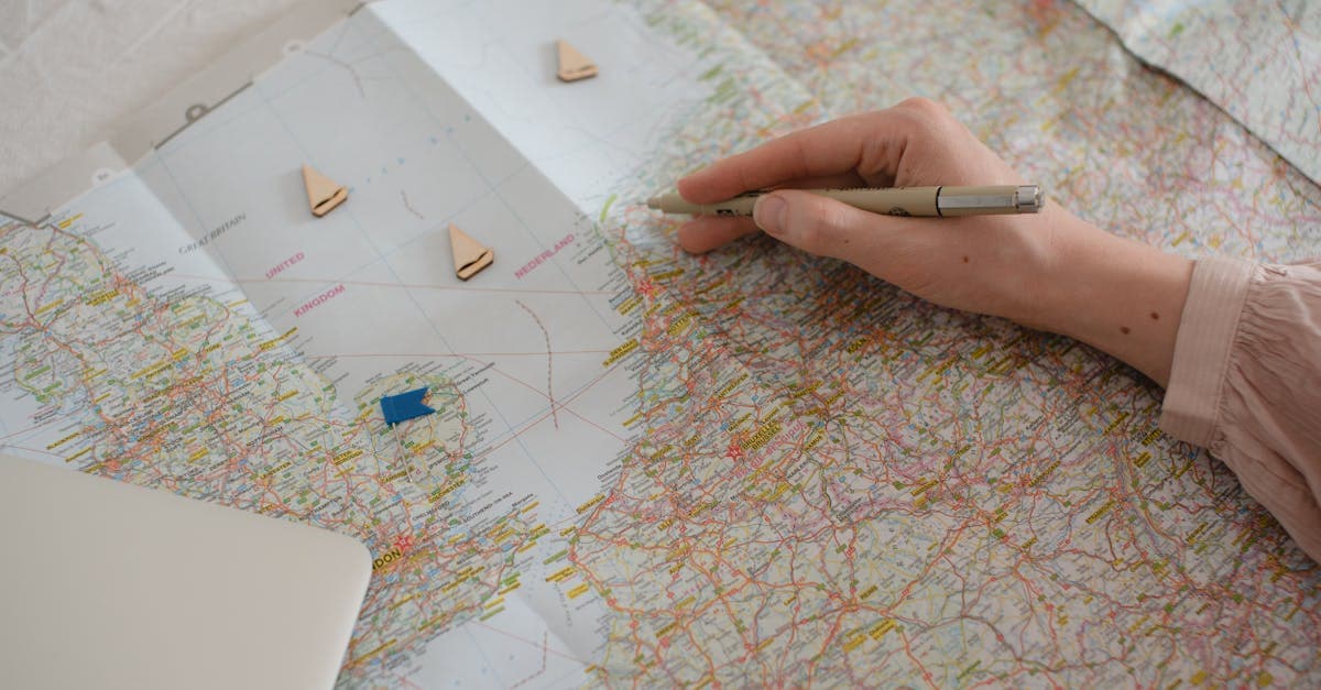 Hand tracing a map route to plan a trip to India during the best travel months by region.