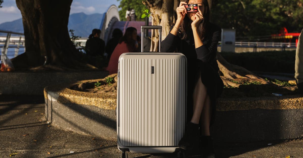 Woman with a suitcase and vintage camera exploring an urban park on a weekend city break