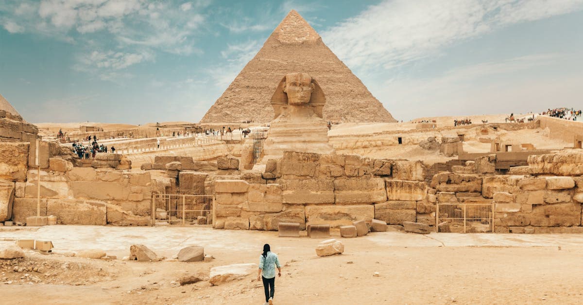Lone traveller walking towards the Great Sphinx, illustrating why many ask is Egypt safe to visit