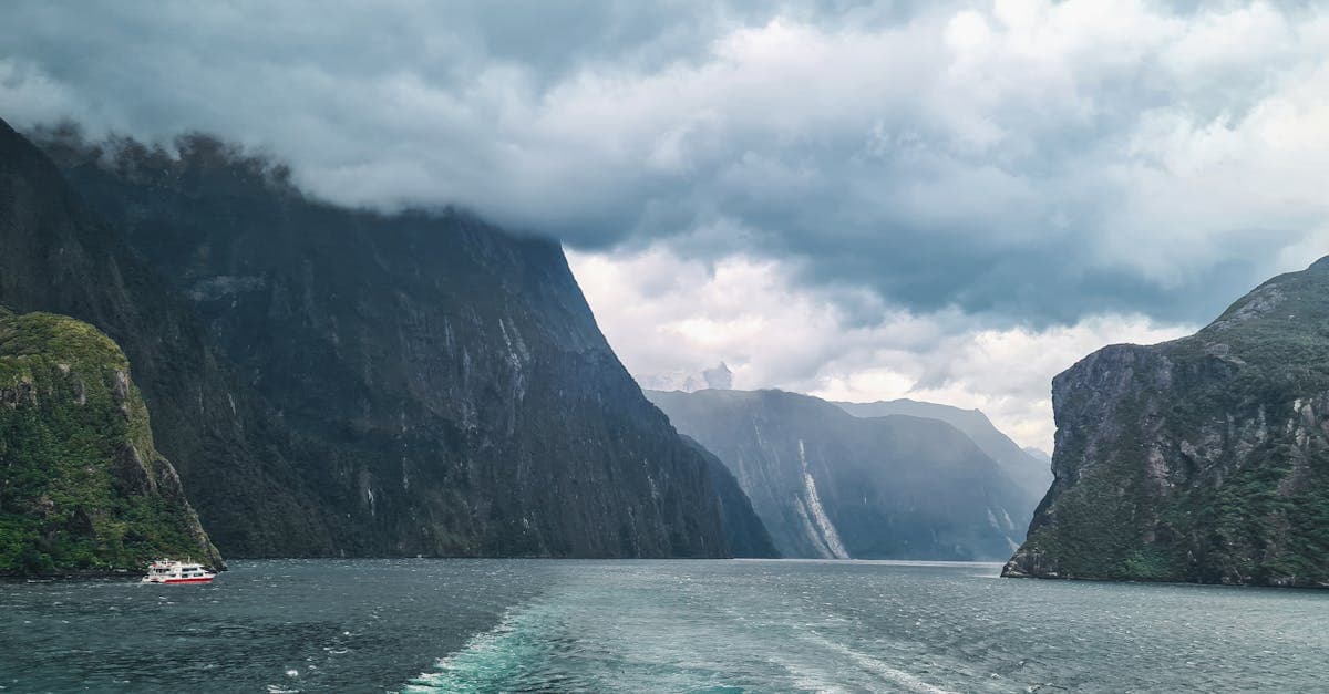 Milford Sound's dramatic fjord landscape with boats, a must-see port on a cruise to New Zealand from Sydney.